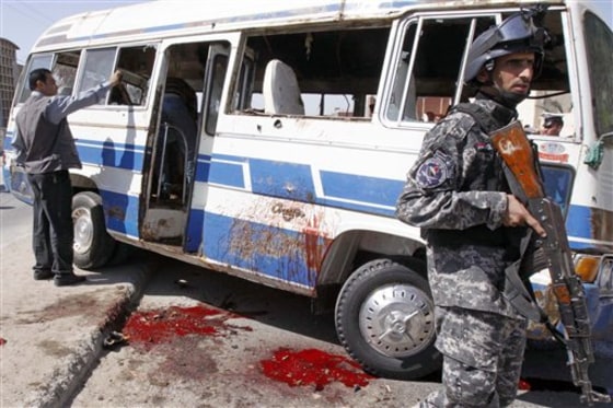 An Iraqi policeman stands guard near a destroyed bus at the site of a bombing in Basra, Iraq's second-largest city, 340 miles southeast of Baghdad, Iraq, on Sunday. Local Iraqi officials say the roadside bomb killed six people and wounded several others.